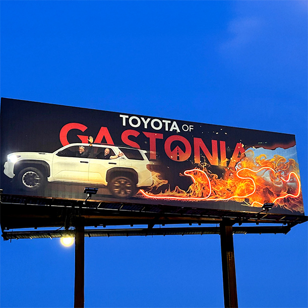 Toyota of Gastonia billboard featuring special cut-out and vibrant illuminated flames