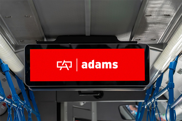 Adams Outdoor Advertising transit example featuring Adams logo over red.